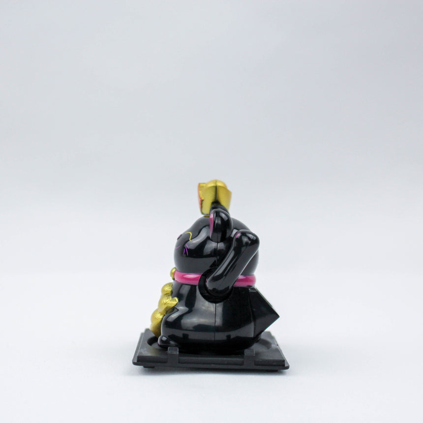 Solar Fortune Cat with Raised Ingot, black side profile with the raised ingot and gold stack visible on a flat black tray